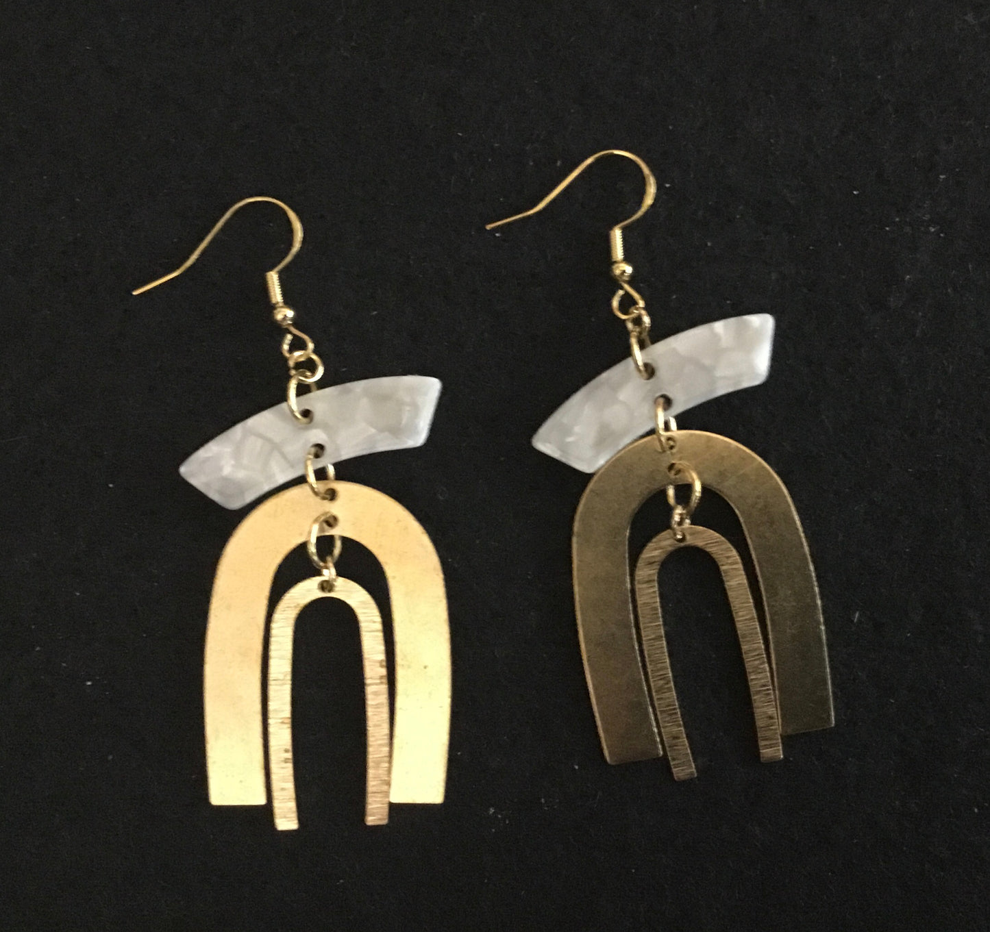White irregular pendant with brass rainbows